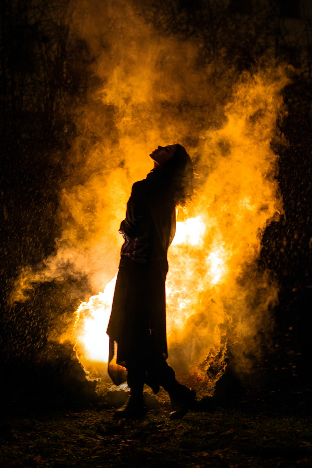a person standing in front of a fire