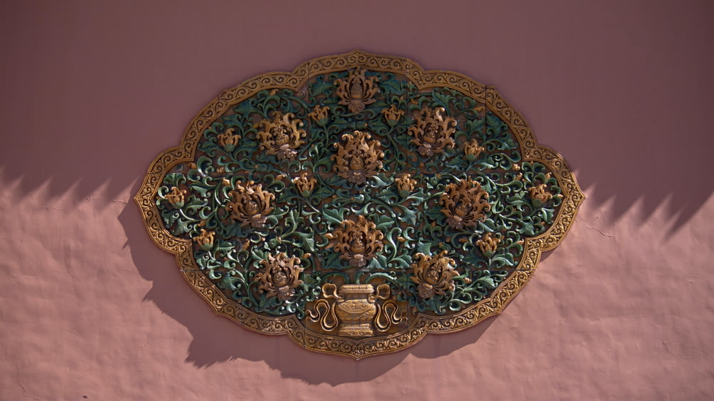 a decorative wall hanging on the side of a building
