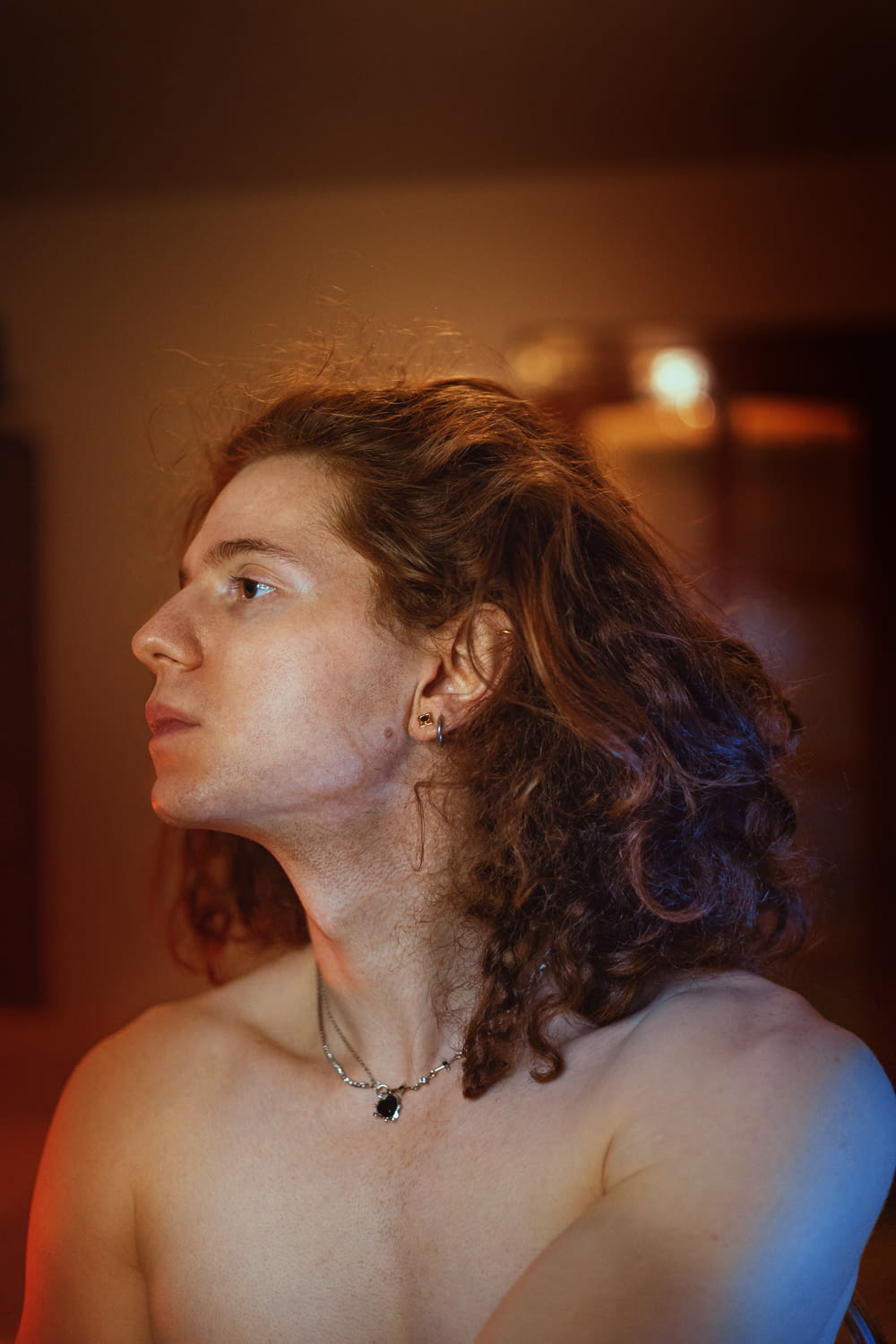 a woman with curly hair is staring off into the distance
