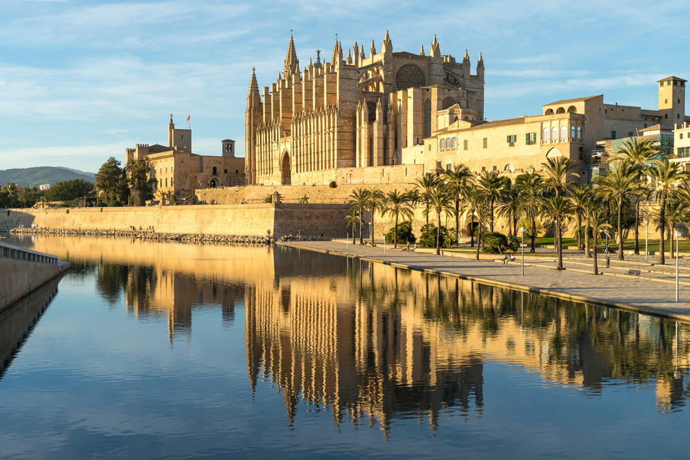 a large cathedral next to a body of water