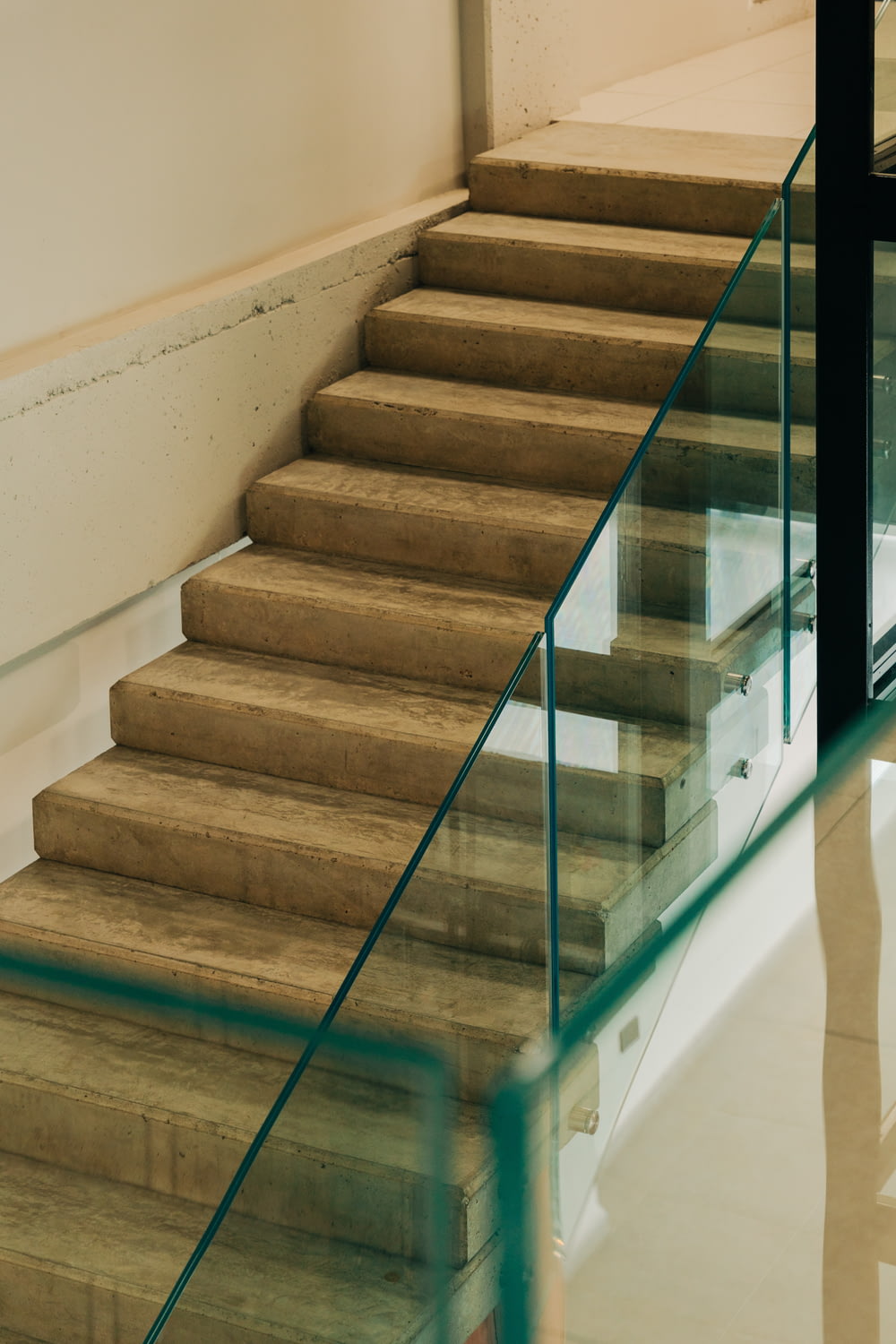 a set of stairs in a building with glass railings