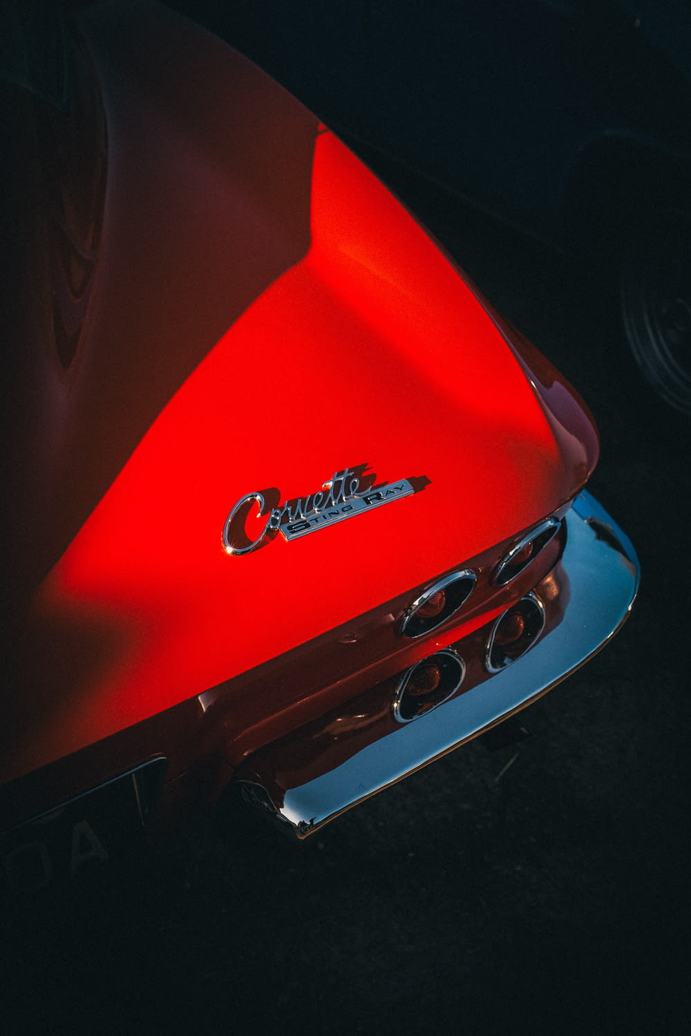 a close up of the hood of a red car