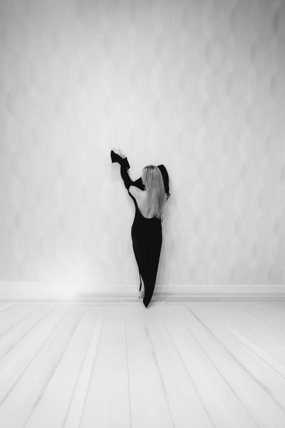a woman in a black dress is dancing