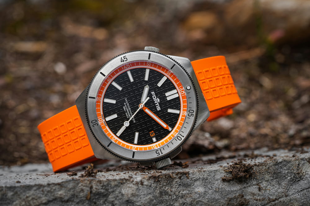 a watch that is sitting on a rock