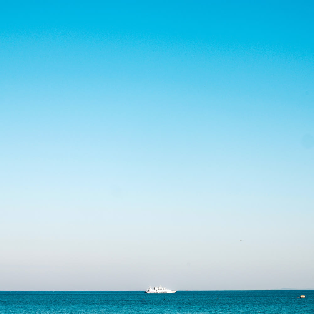 a boat is out in the ocean on a clear day