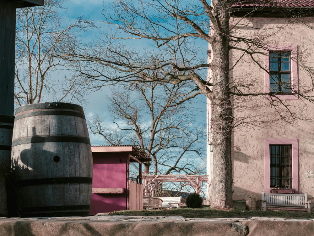 a large barrel sitting next to a building