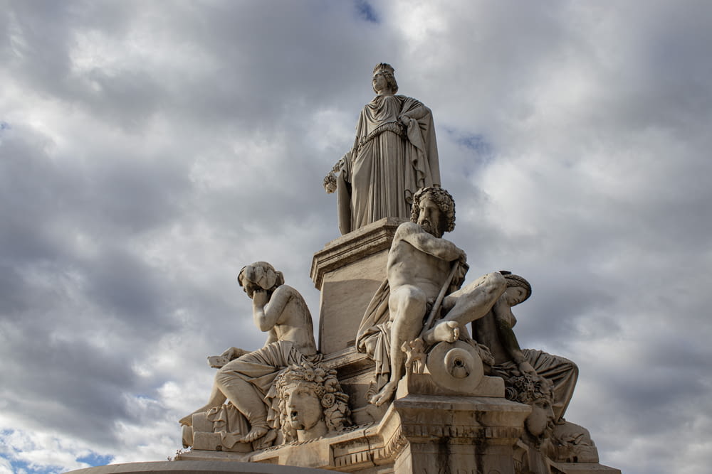 a statue of a man sitting on top of a statue