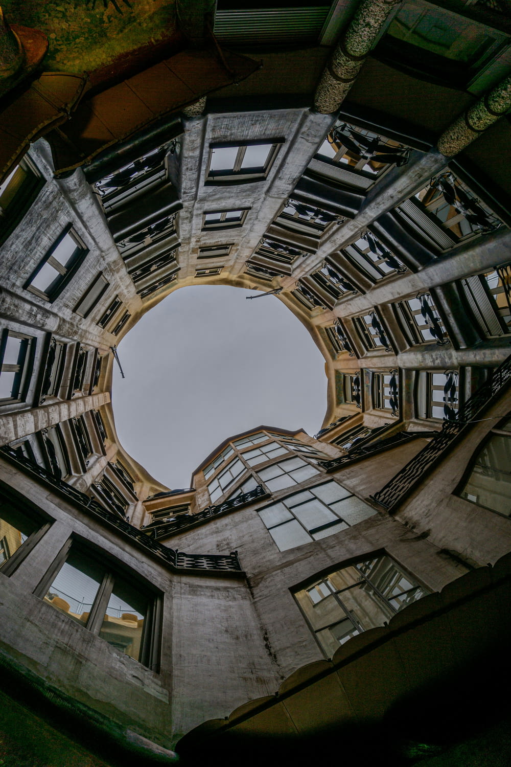 looking up at a circular window in a building