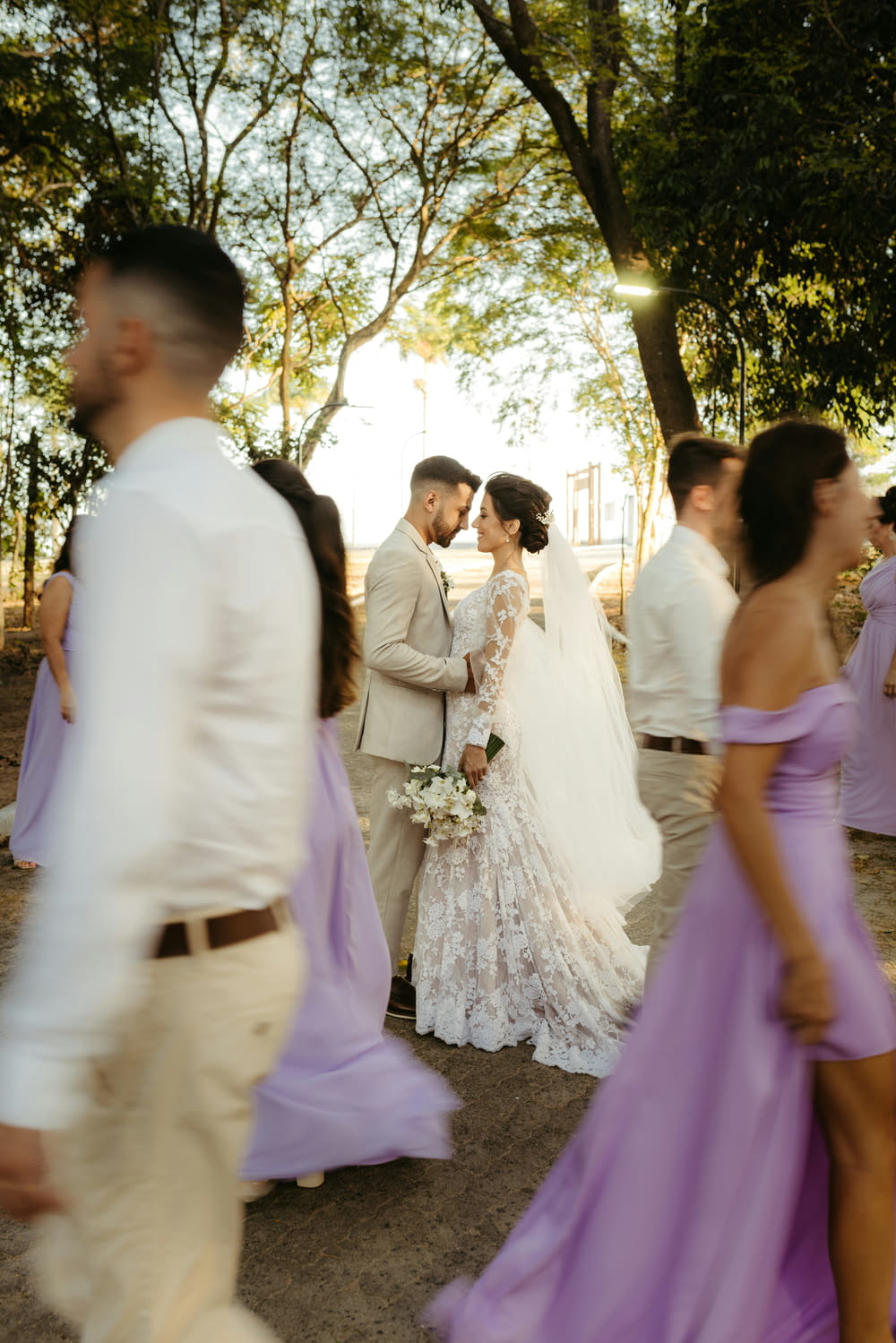 a bride and groom standing in front of a group of people