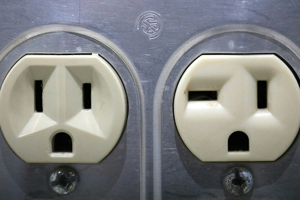 a couple of white electrical outlets sitting next to each other