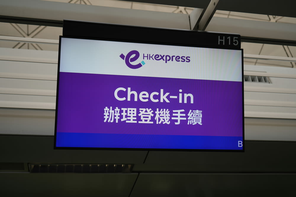 a sign that says check - in in in an airport