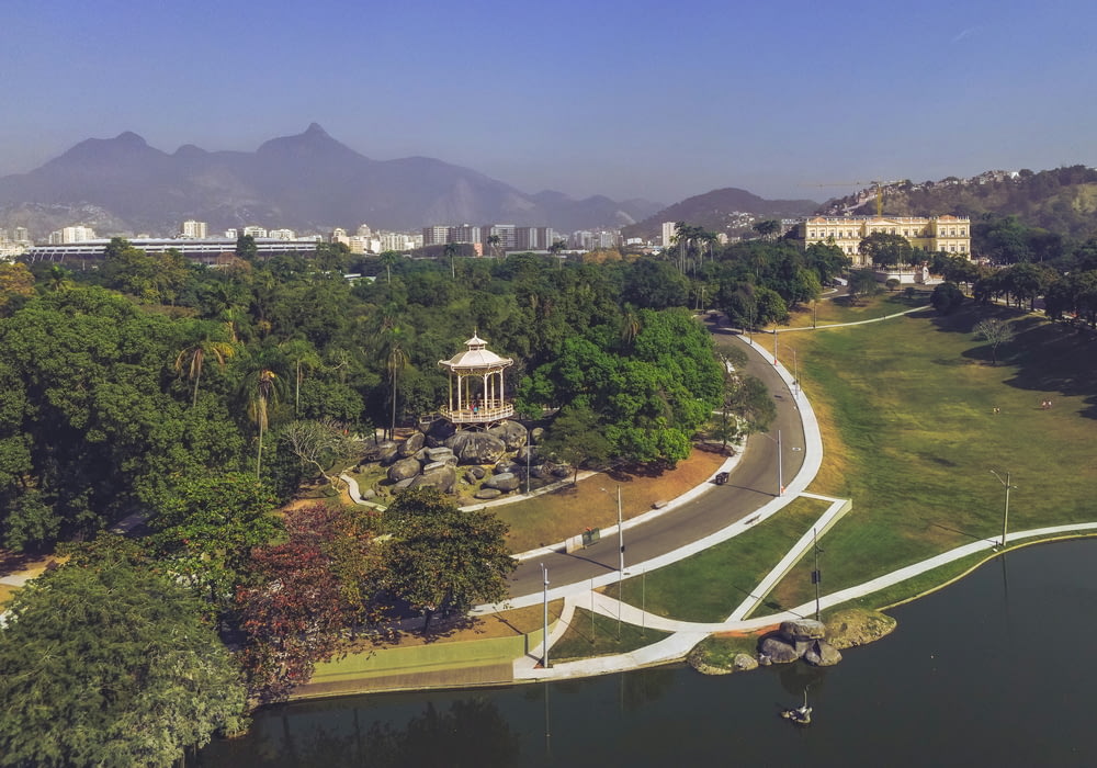 an aerial view of a park with mountains in the background