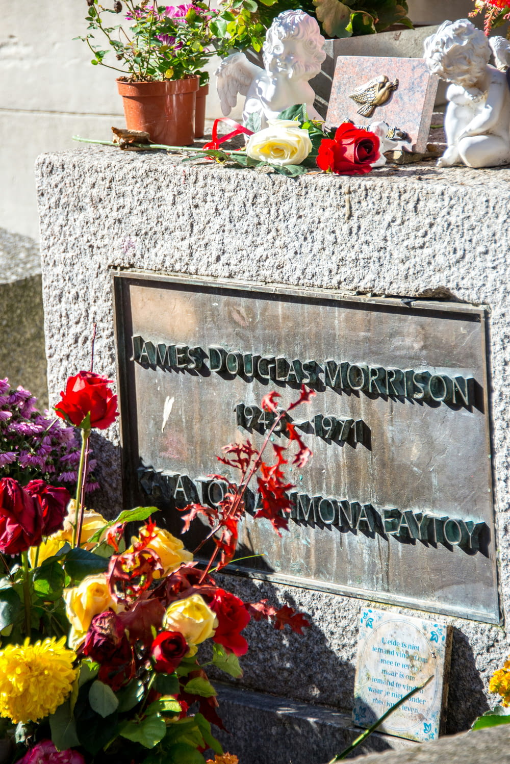 a memorial with flowers and pictures on it