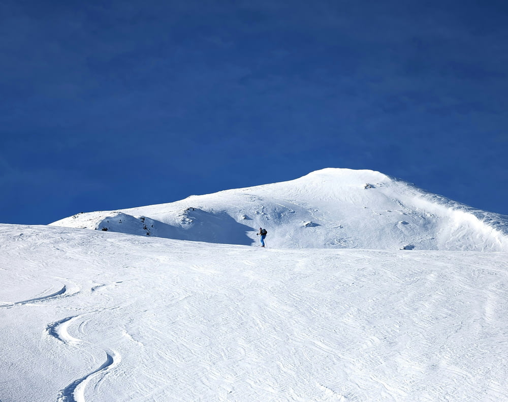 a person standing on a snow covered slope
