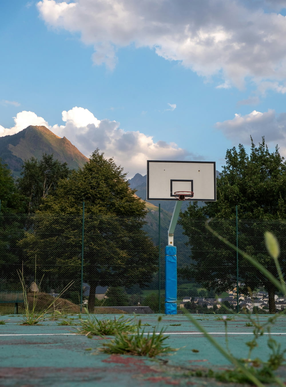 a basketball court with a basket in the middle of it