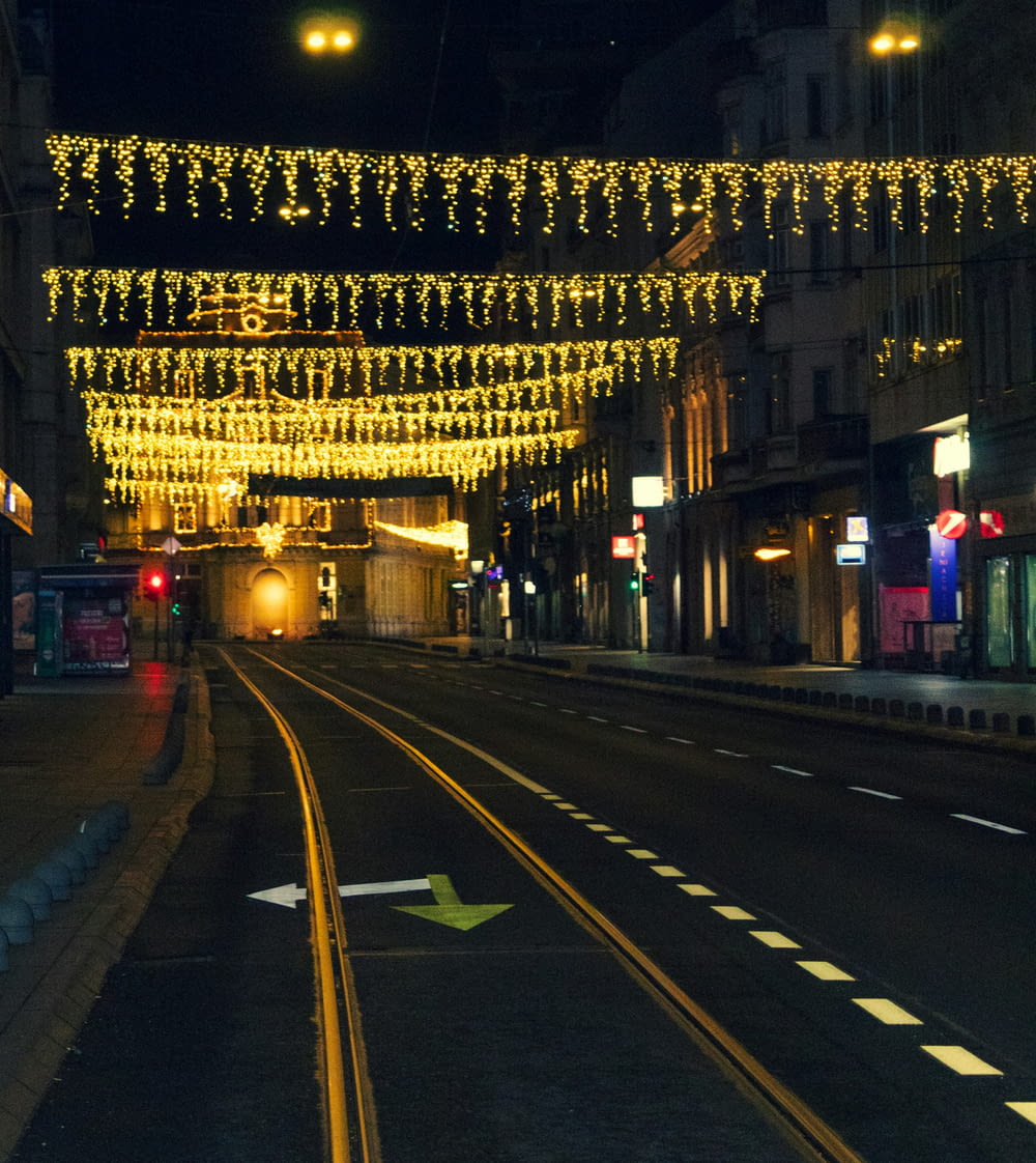 a city street with lights strung over it