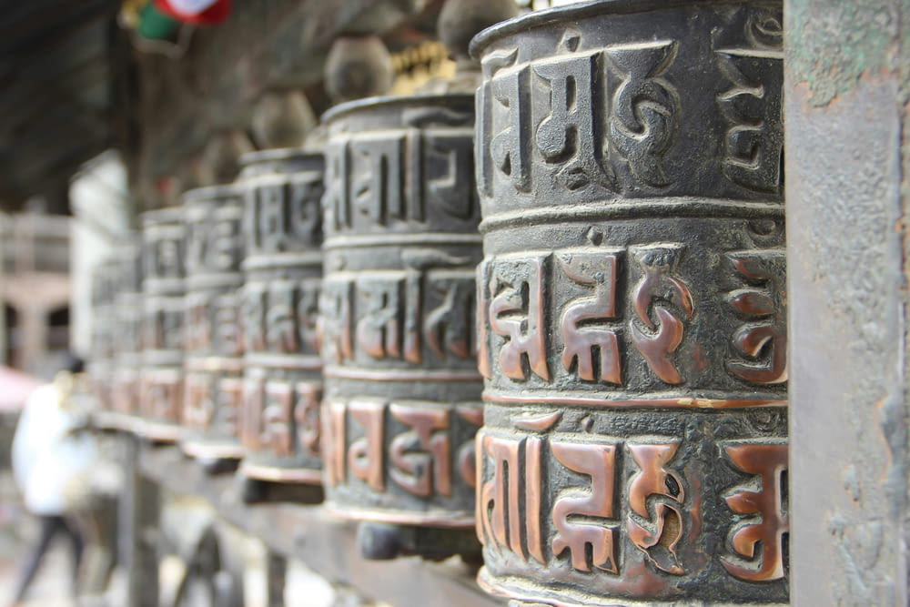 a row of metal bells with asian writing on them