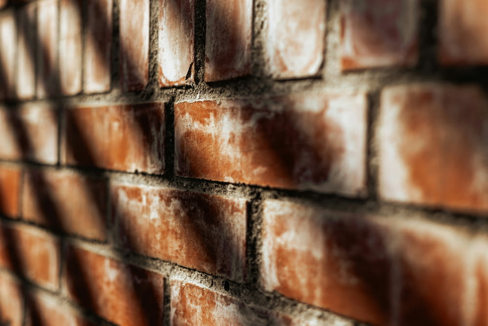 a brick wall with a shadow cast on it