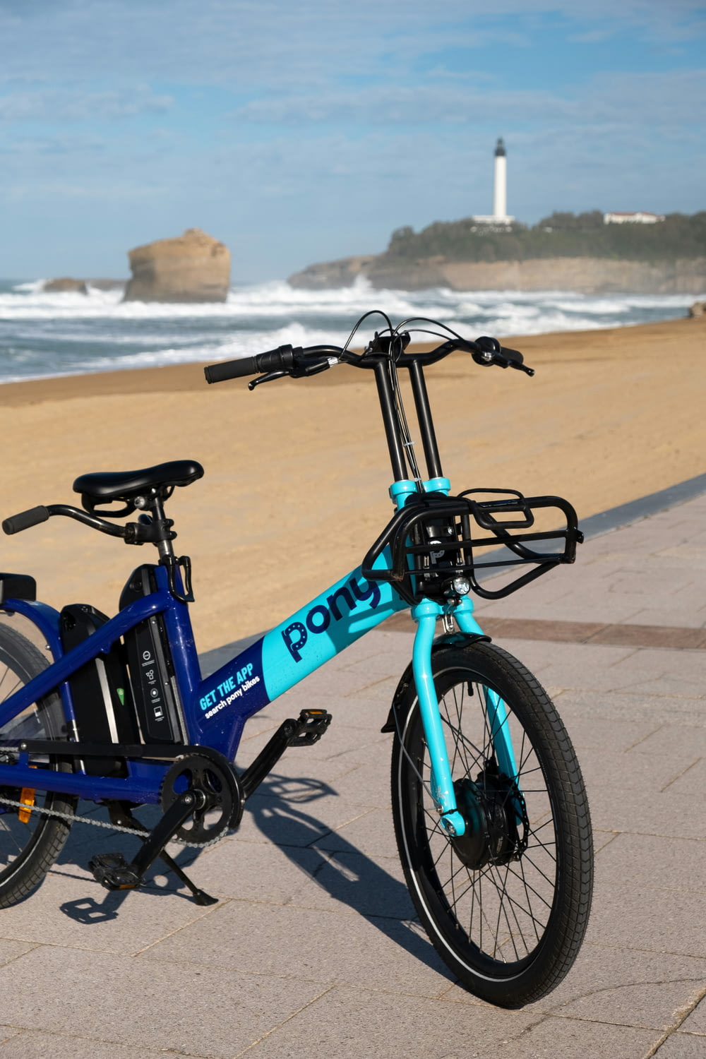 a blue bicycle parked on the side of a beach