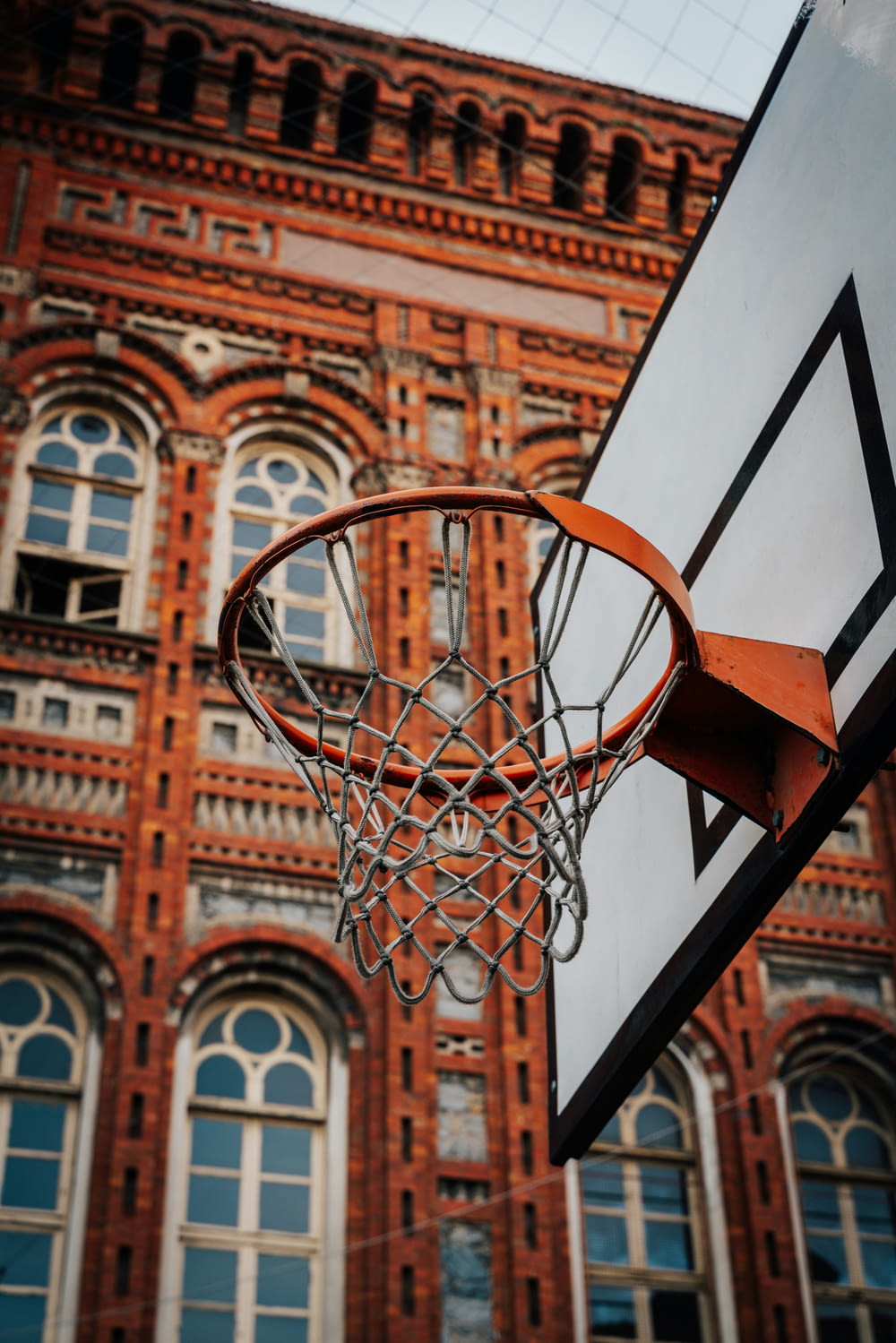 a basketball hoop with a building in the background