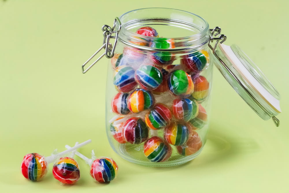 a jar filled with candy sitting on top of a table