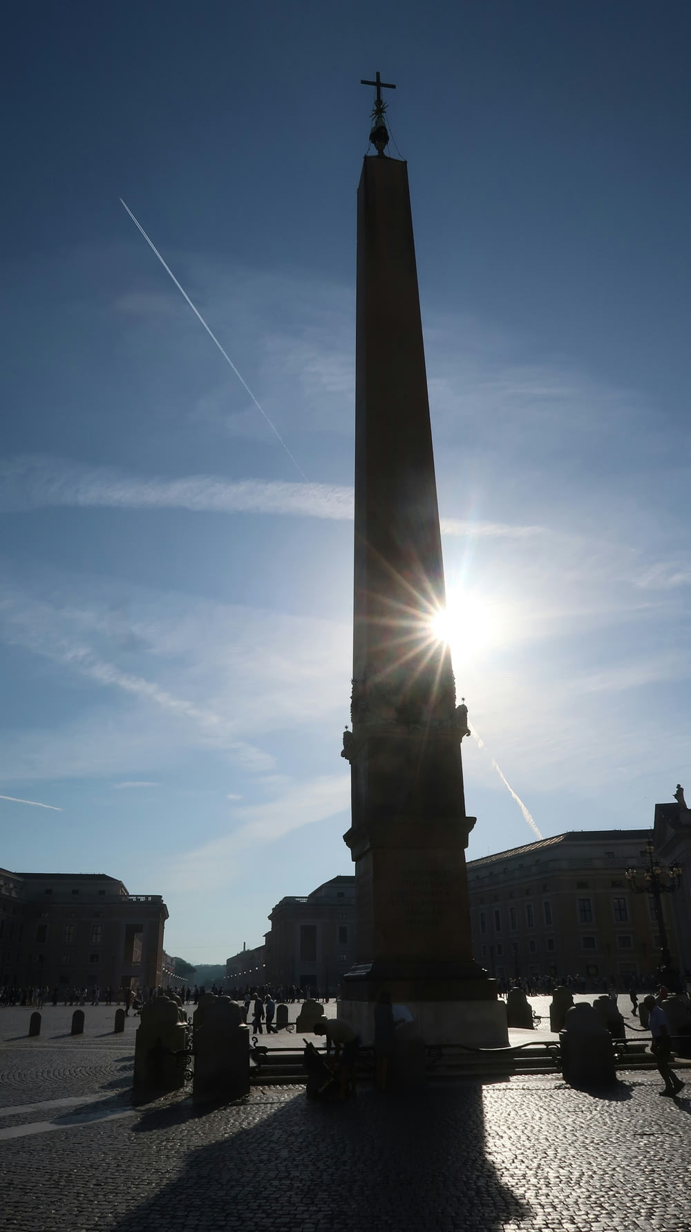 the sun is shining behind a tall monument