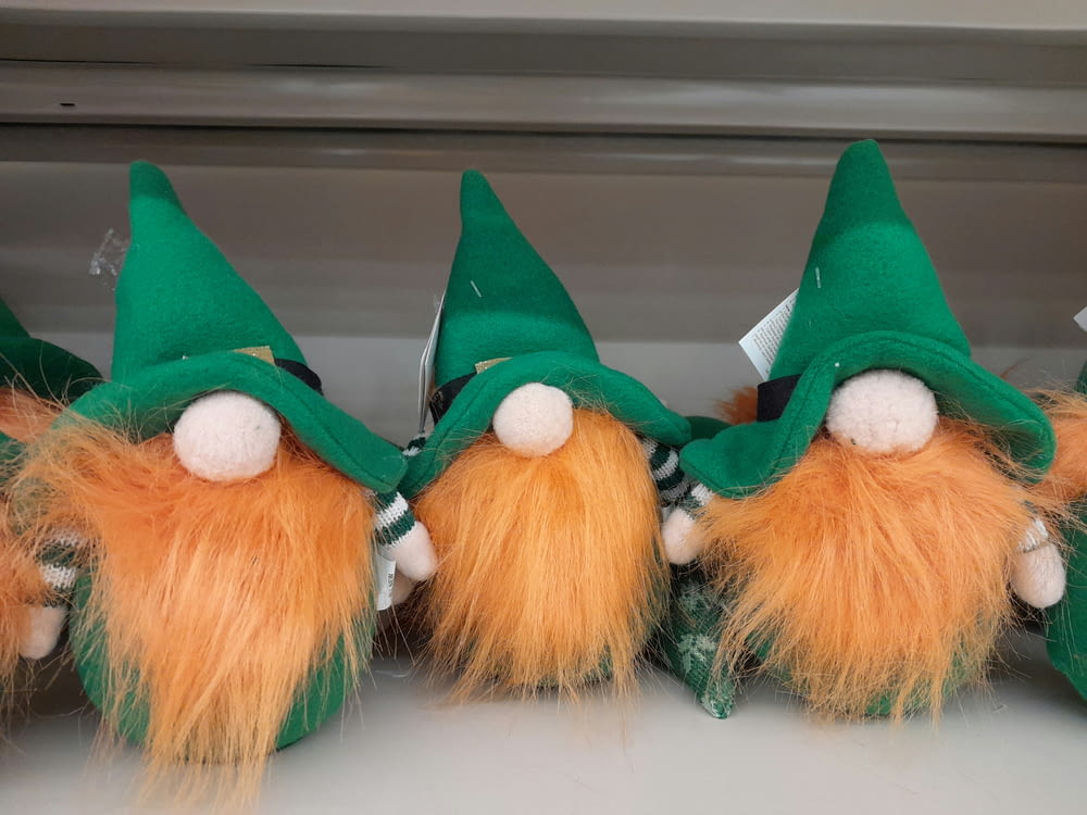 a group of green and orange gnomes sitting next to each other