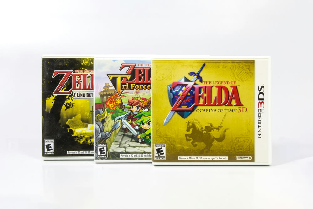 three nintendo games are shown on a white surface