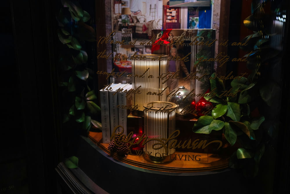 a window display with candles and christmas decorations