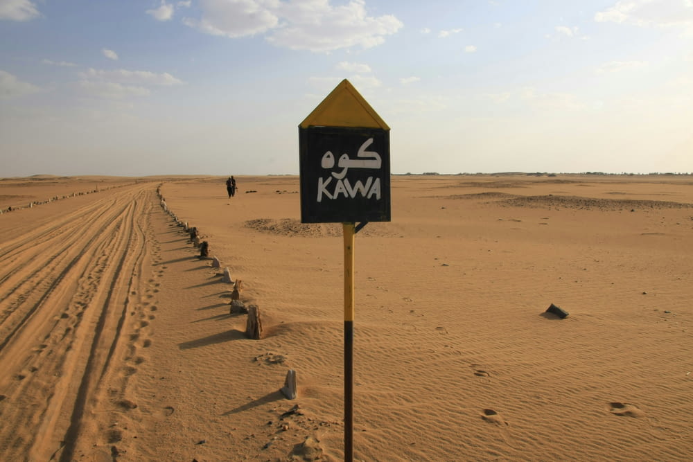 a sign that is in the middle of a desert