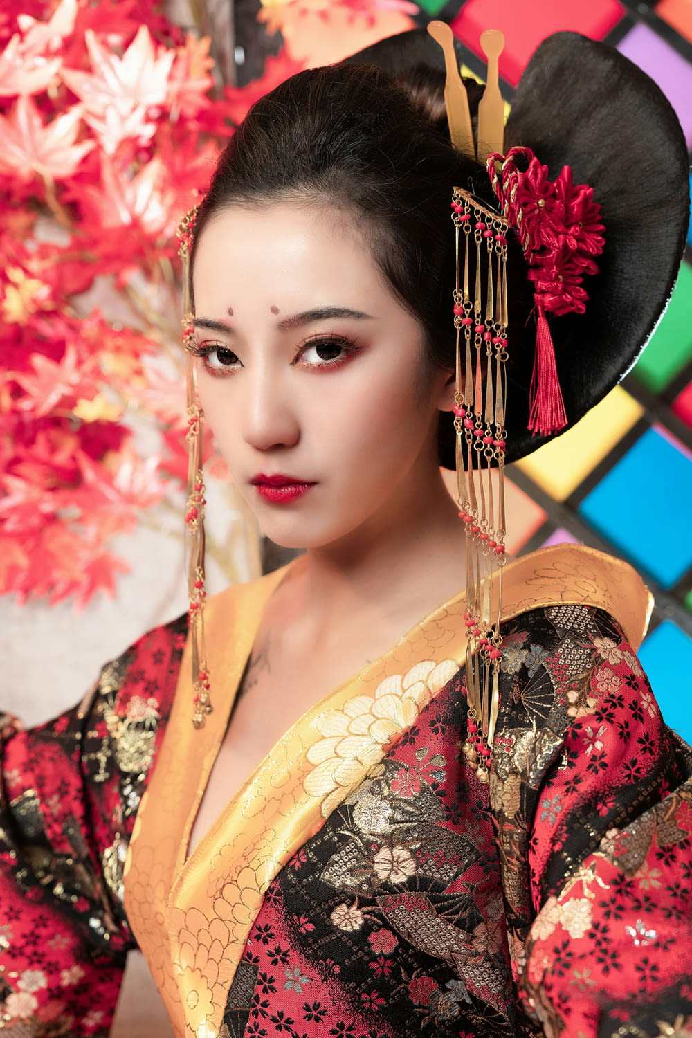 a woman in a geisha dress with a red flower in her hair