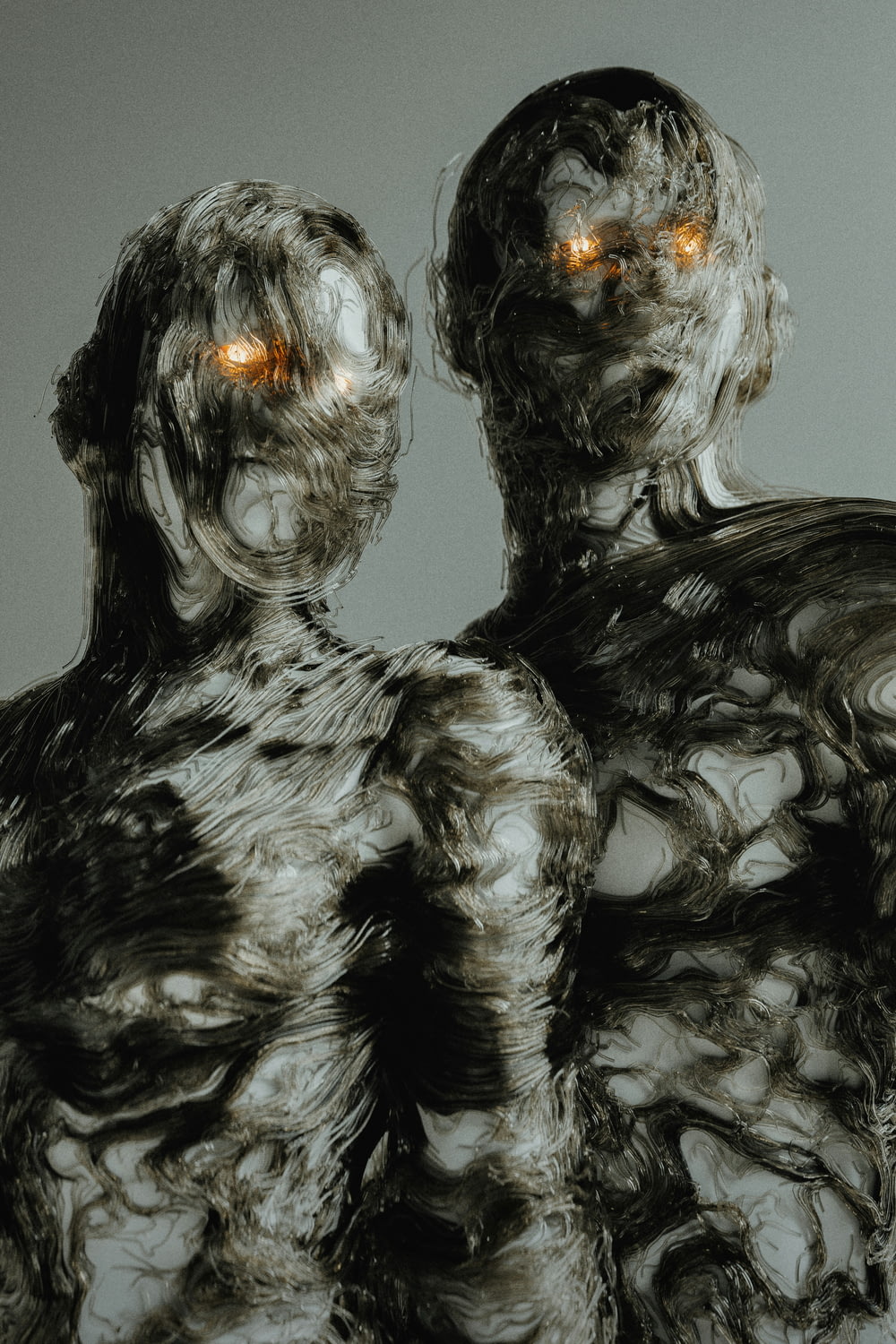a couple of weird looking figures with glowing eyes