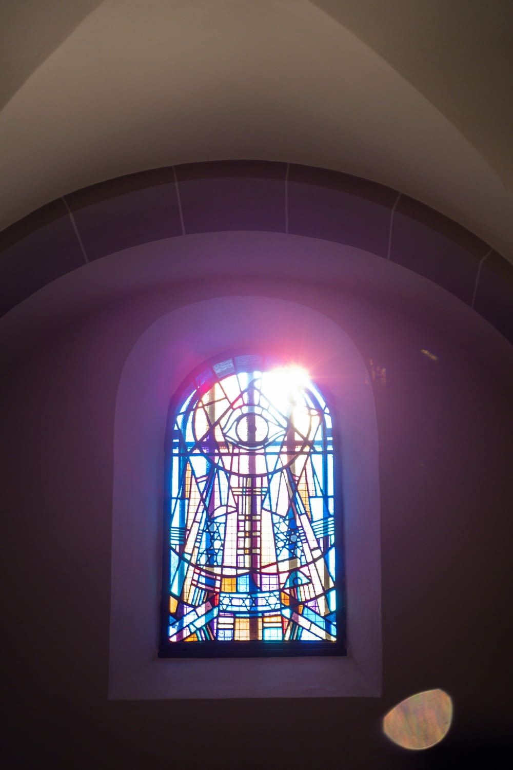 a colorful stained glass window in a church