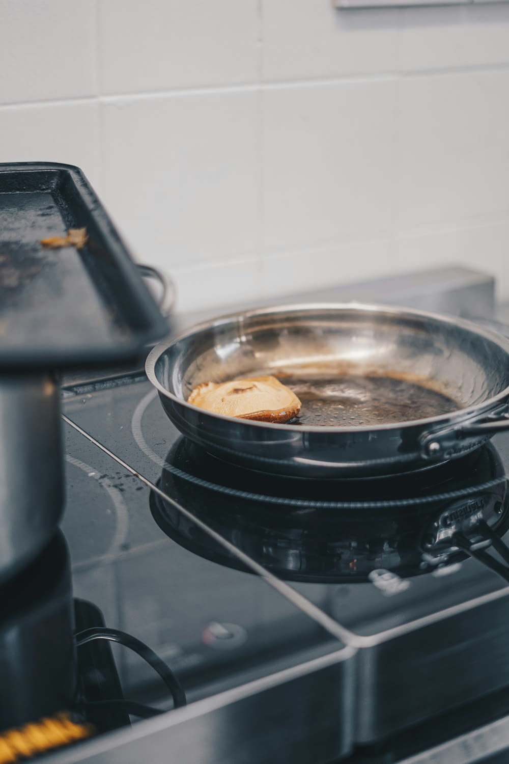 a frying pan on a stove with food cooking in it