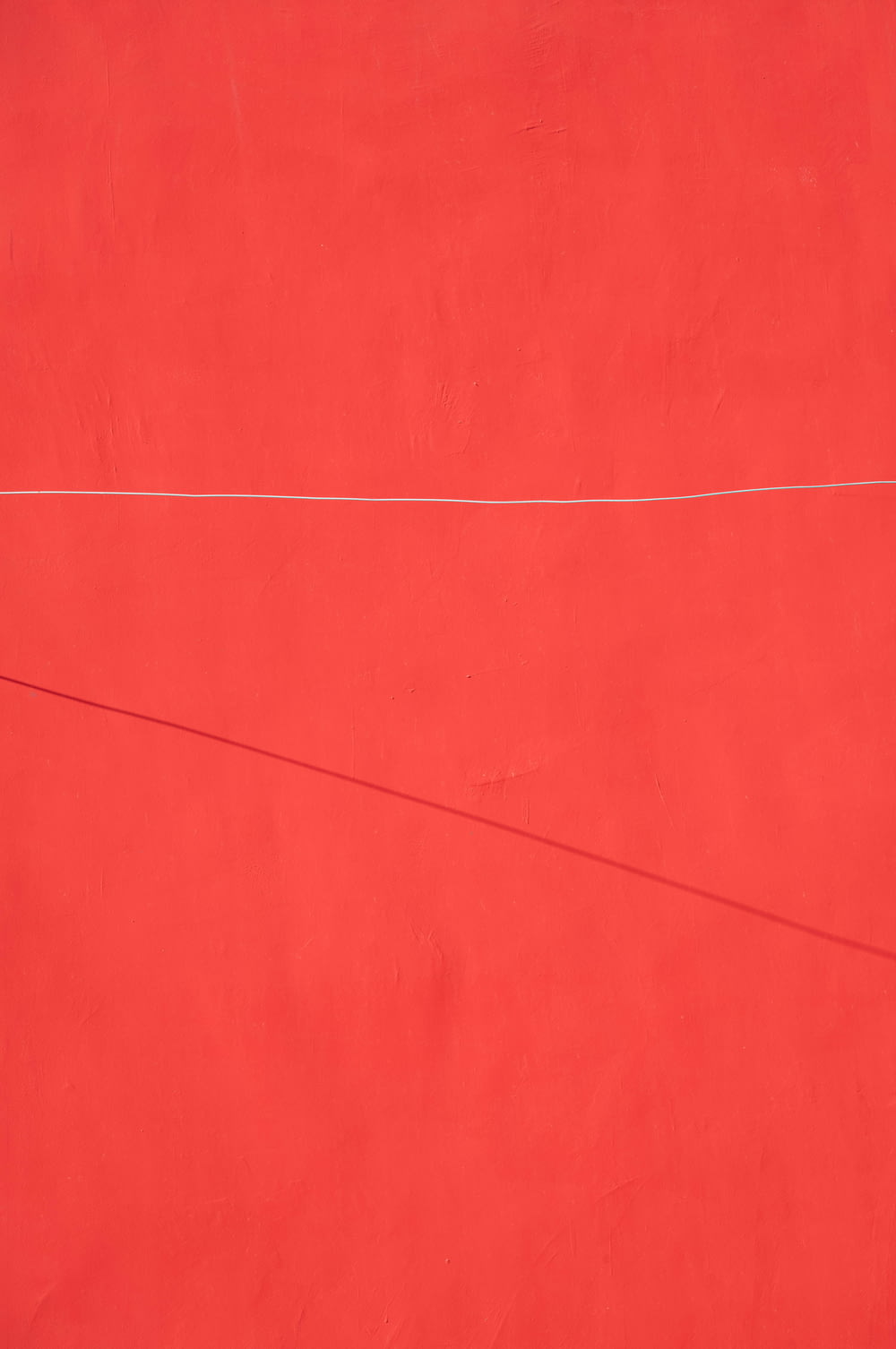 a red wall with a white line on it