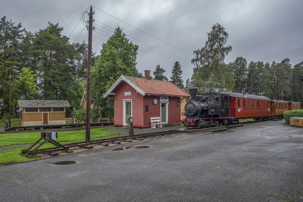 a small train station with a train on the tracks