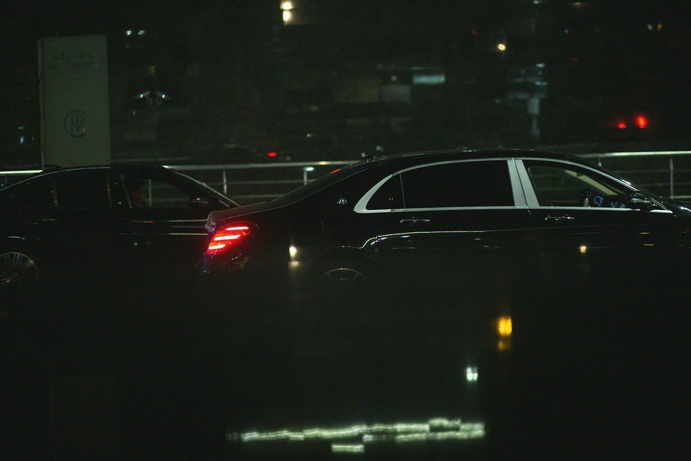 a couple of cars that are sitting in the dark