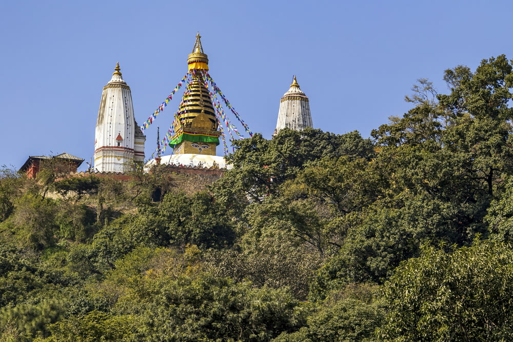 a large golden and white building on top of a hill