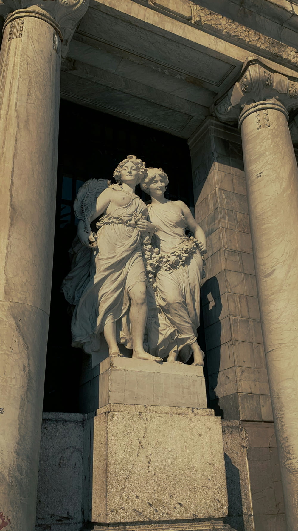 a statue of two women standing next to each other