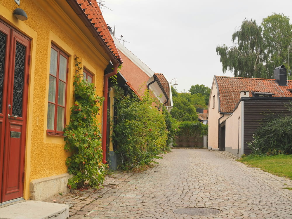 a cobblestone street lined with yellow buildings