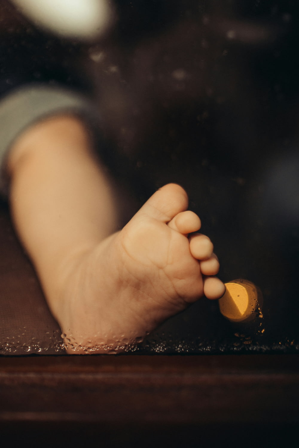 a close up of a baby's foot and hand