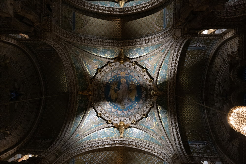 the ceiling of a large building with intricate designs