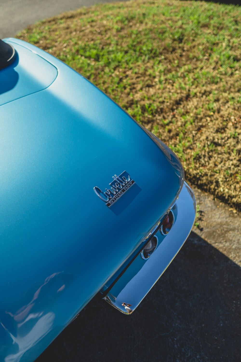 a close up of the hood of a blue car