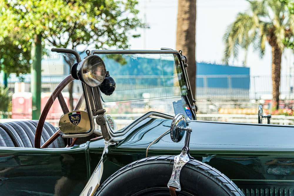 an old car with a steering wheel and a leather seat
