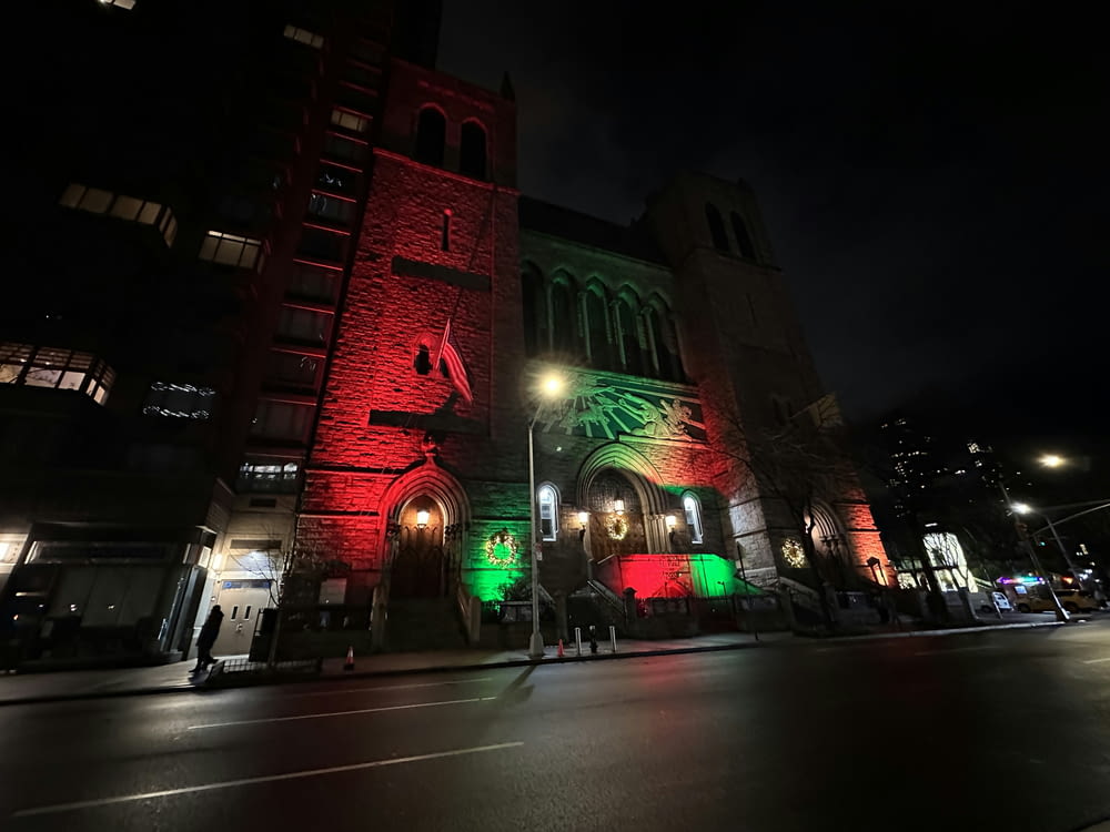 a church lit up with red and green lights