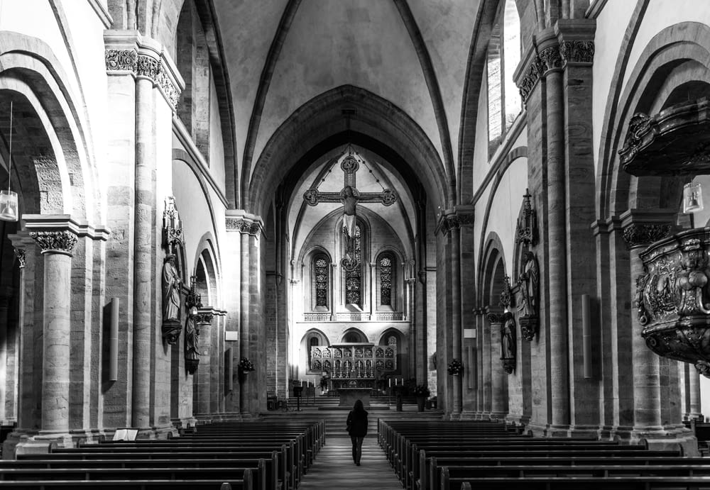 a black and white photo of a church with pews