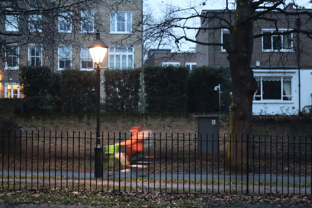 a park bench sitting next to a street light