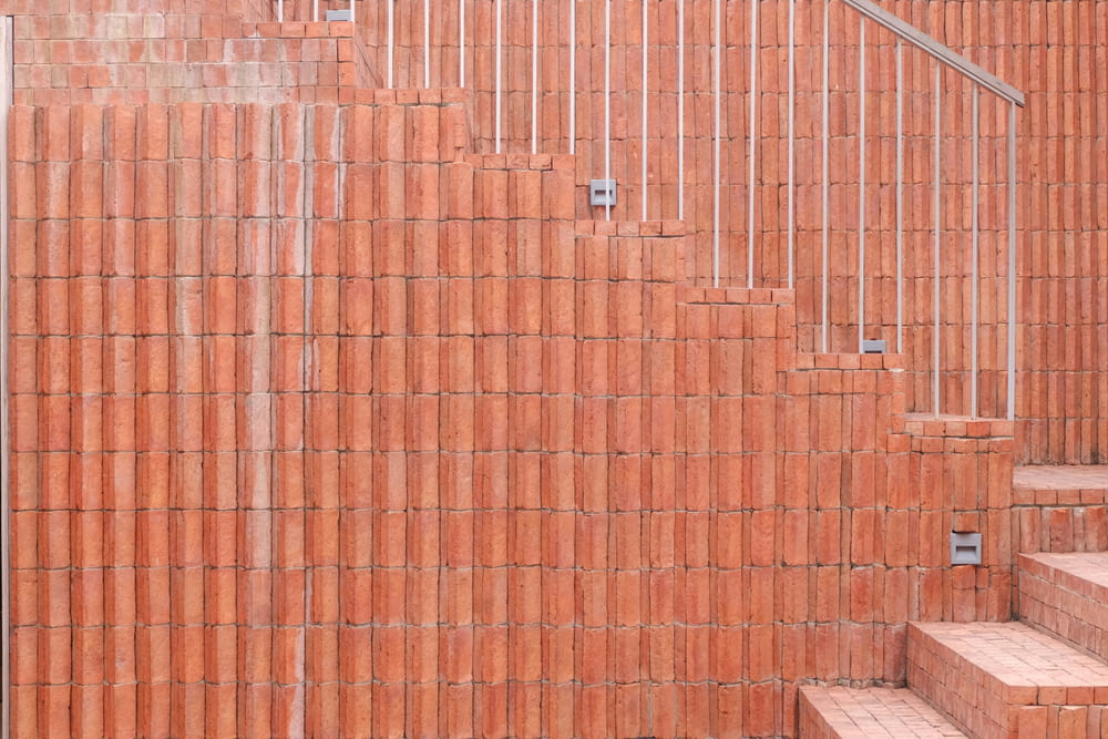 a red brick wall with steps leading up to it