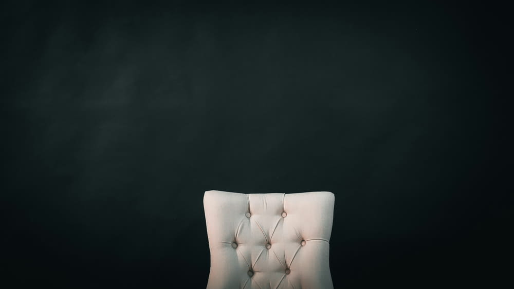 a white chair against a black background