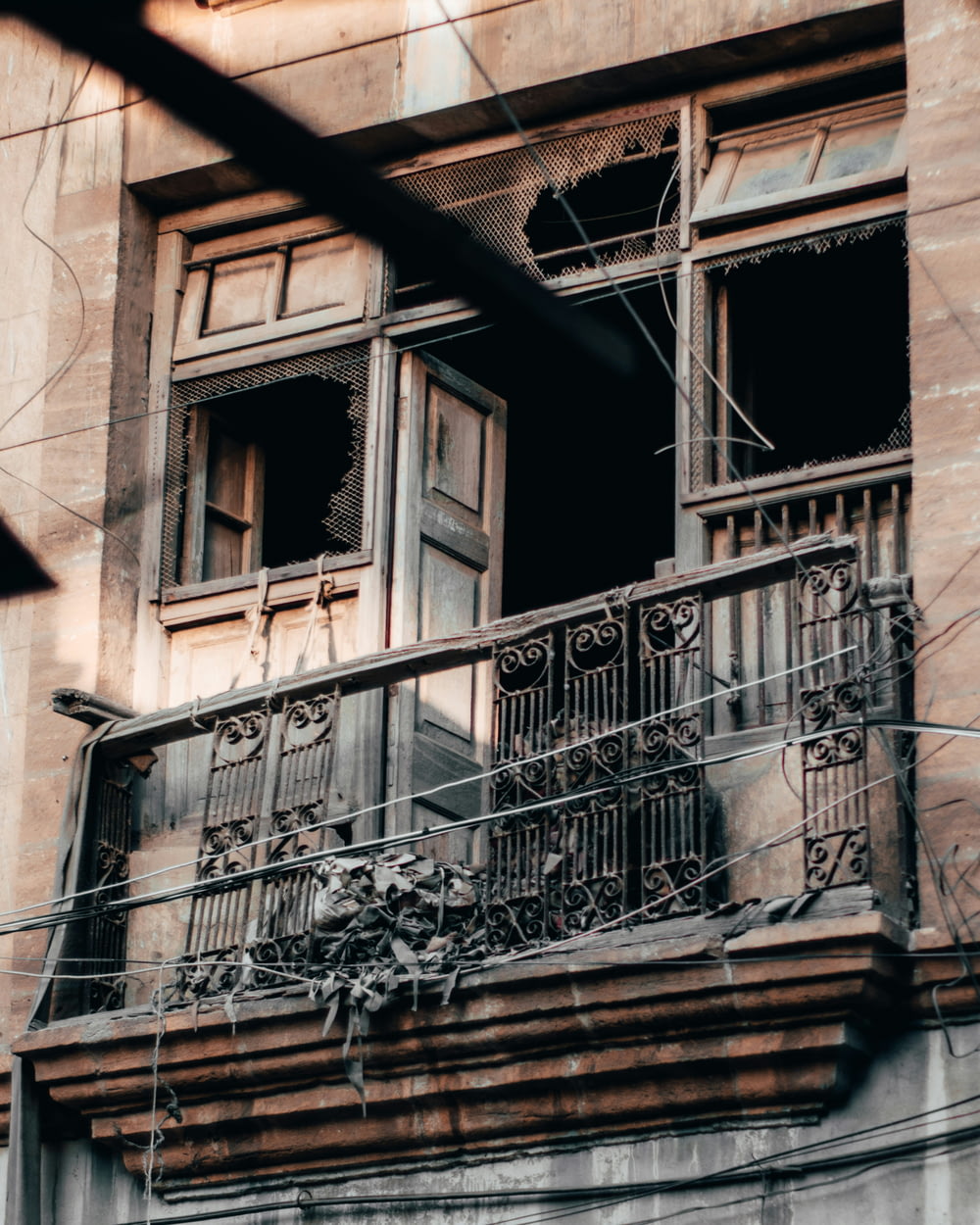 an old building with a balcony and wrought iron railing